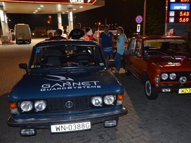 Stare samochody na stacji benzynowej.