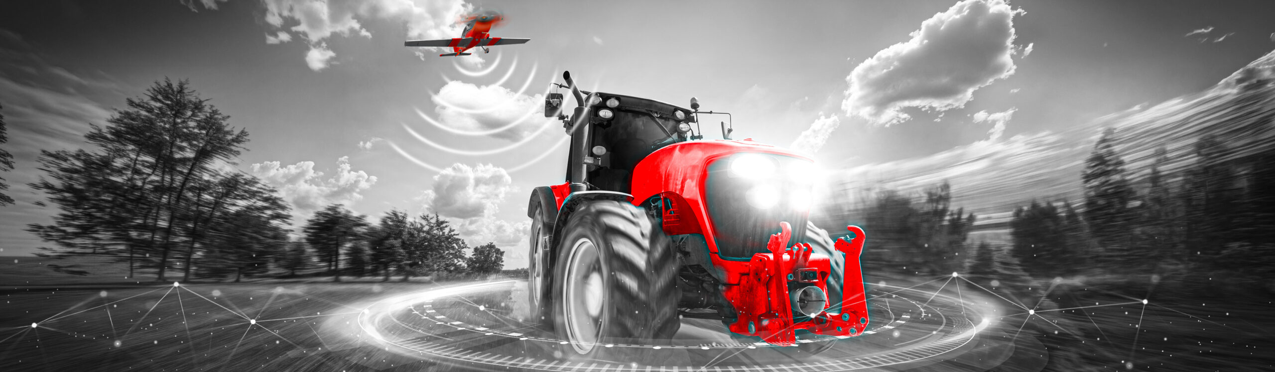 Czerwony traktor w nowoczesnym krajobrazie. zabezpieczenie maszyn rolniczych